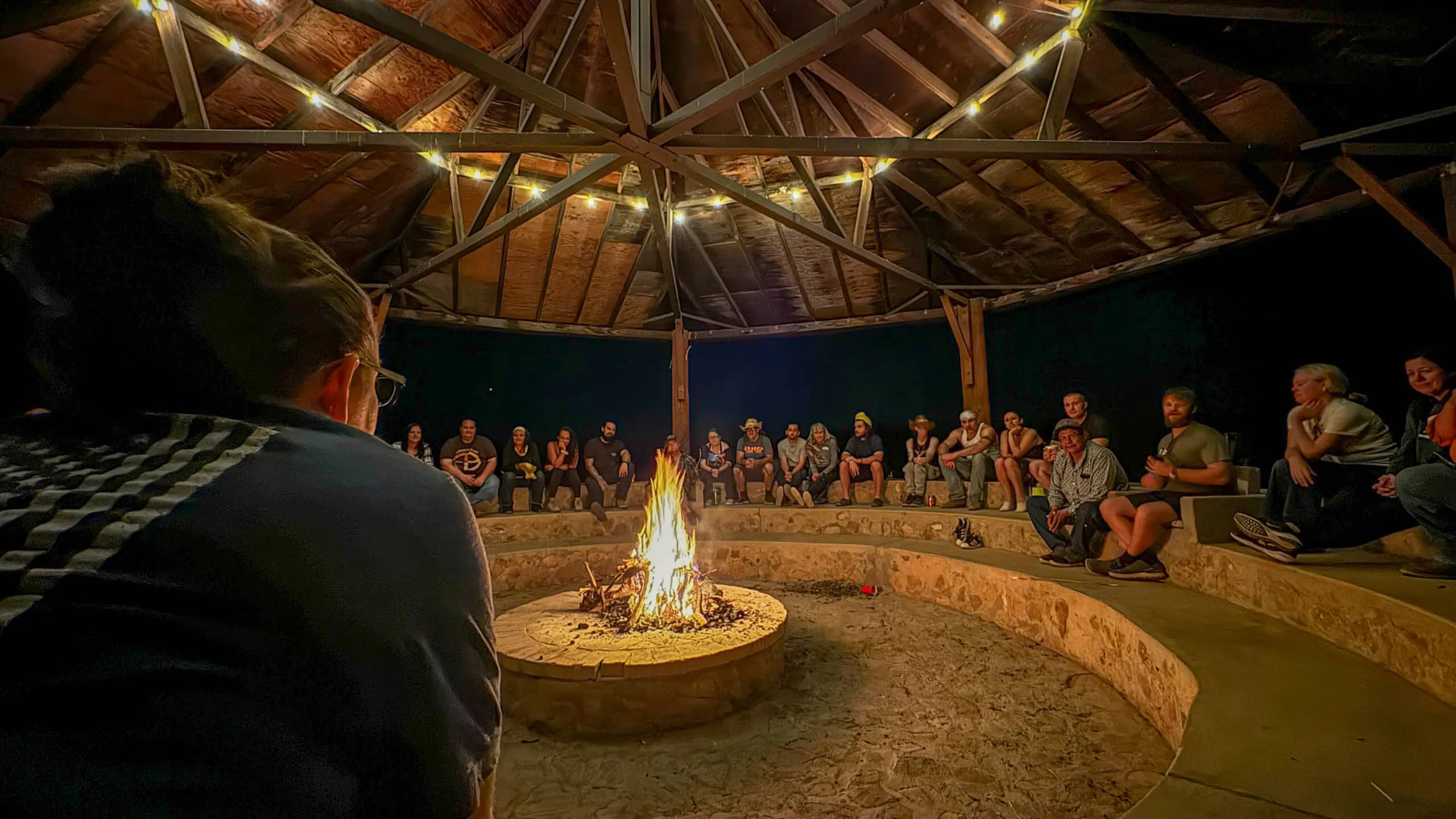 Ceremony circle around an evening campfire at Seven Arrows.