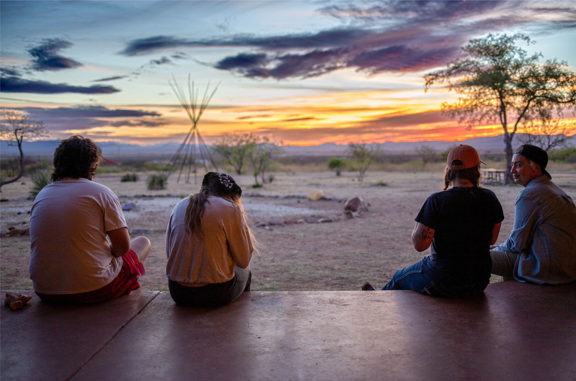 Group watching sunset in the desert